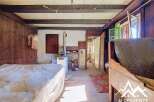 Step into a rustic charm with this unique property, featuring exposed wooden beams and traditional wood-paneled walls that evoke a sense of history and warmth.
