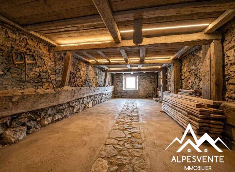 Discover this charming rustic interior, featuring exposed stone walls and robust wooden beams that evoke a sense of history and warmth.