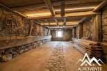 Discover this charming rustic interior, featuring exposed stone walls and robust wooden beams that evoke a sense of history and warmth.