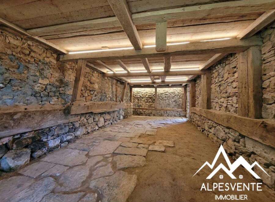 Discover the rustic charm of this unique property, featuring exposed stone walls and original wooden beams that evoke a sense of history and character.