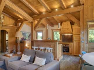 Experience rustic charm in this mountain retreat featuring exposed wooden beams and a cozy living area.