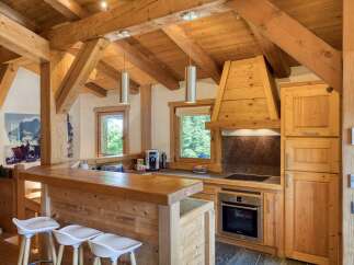 Experience rustic charm in this beautifully appointed wooden kitchen, featuring a spacious breakfast bar perfect for casual dining.