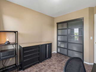 This office space features a sleek black rolling cabinet with a wooden countertop, perfect for storage and workspace.
