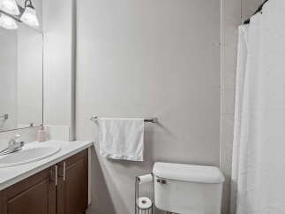 This bathroom features a clean and functional design with a spacious vanity and a large mirror.