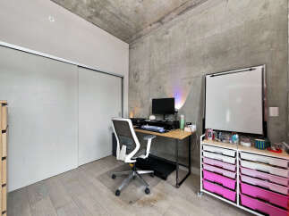 This modern home office features a sleek desk with a computer setup, an ergonomic chair, and a whiteboard for brainstorming.