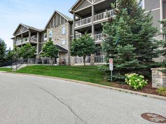 Discover modern living in this stunning condo building, featuring a beautiful stone and wood exterior.