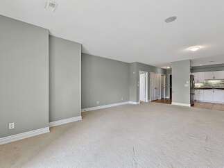 Step into this spacious open-concept living area, perfect for modern living and entertaining.