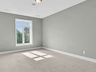Step into this bright and airy room, featuring a large window that floods the space with natural light.