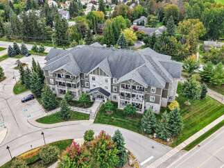 Discover modern living in this stunning multi-story apartment building, nestled amidst lush greenery and mature trees.