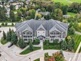 Experience luxury living in this stunning multi-story apartment building, featuring a modern facade with stone and wood accents.