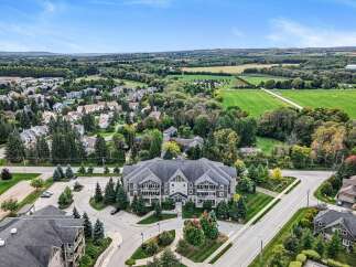 Discover this stunning multi-unit residential building nestled amidst lush greenery and scenic countryside views.