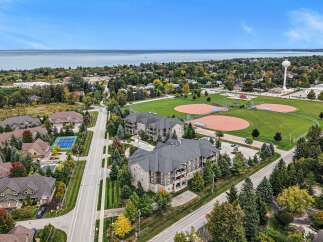 Discover this stunning aerial view showcasing a vibrant community with modern apartment buildings and charming single-family homes.