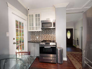 Step into this charming kitchen featuring a sleek stainless steel gas range and microwave, perfect for culinary adventures.
