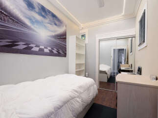 This bedroom features a striking race track mural, creating a dynamic and energetic atmosphere.