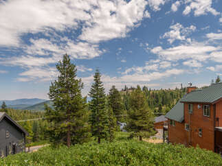 Experience breathtaking mountain views from this stunning property, nestled amidst a lush pine forest.