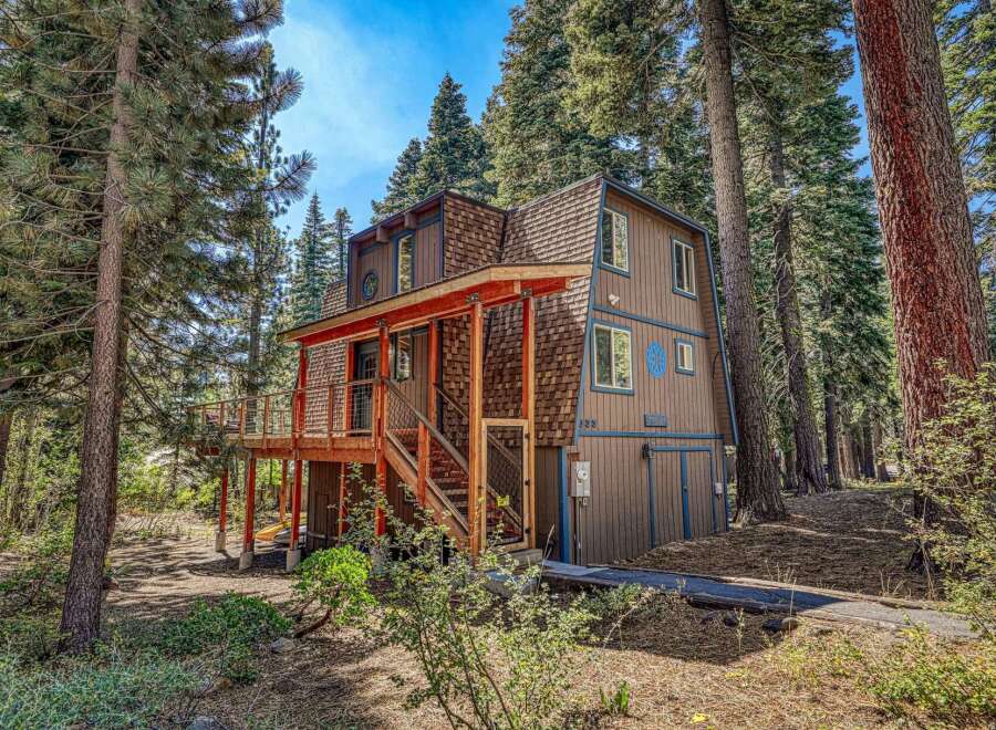 Nestled amongst towering pine trees, this charming cabin offers a serene mountain retreat.