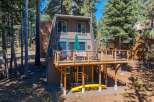 Experience the ultimate mountain getaway in this charming A-frame cabin nestled among tall pine trees.