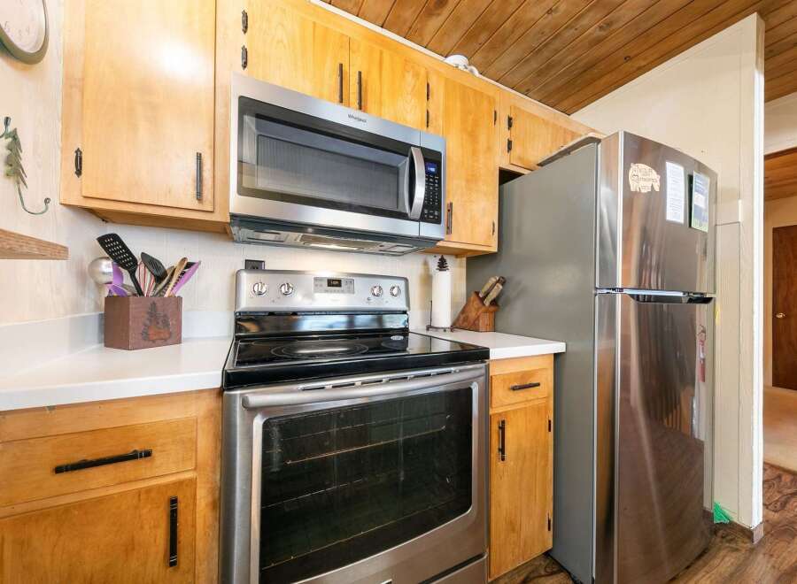 This kitchen boasts a full suite of stainless steel appliances, including a microwave, oven, and refrigerator, perfect for any home chef.