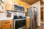 This kitchen boasts a full suite of stainless steel appliances, including a microwave, oven, and refrigerator, perfect for any home chef.