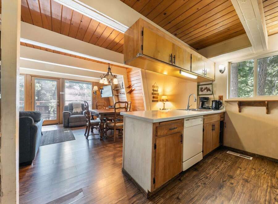 Cozy cabin living with a charming open-concept kitchen and dining area, perfect for gatherings.