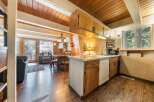 Cozy cabin living with a charming open-concept kitchen and dining area, perfect for gatherings.