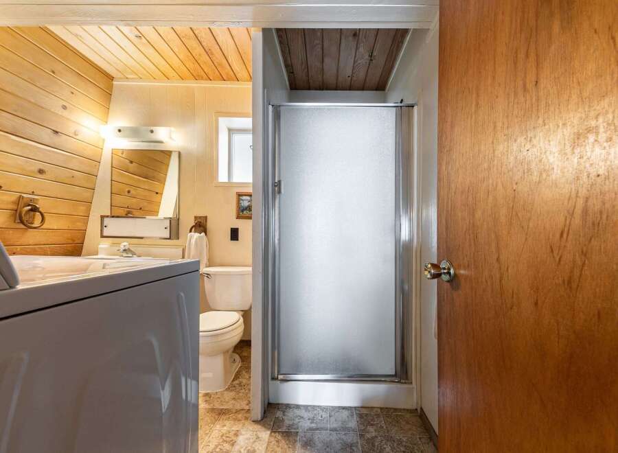This bathroom features a convenient in-unit washer and dryer, perfect for busy households.