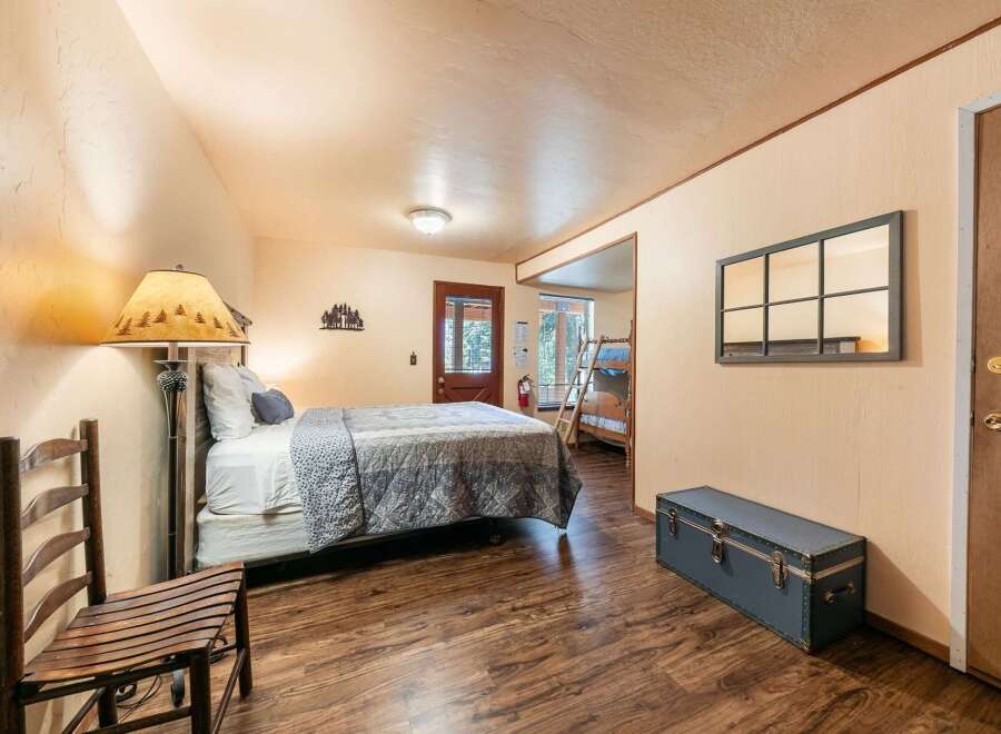 This charming room offers a comfortable queen-size bed with a cozy quilted comforter, perfect for a restful night's sleep.