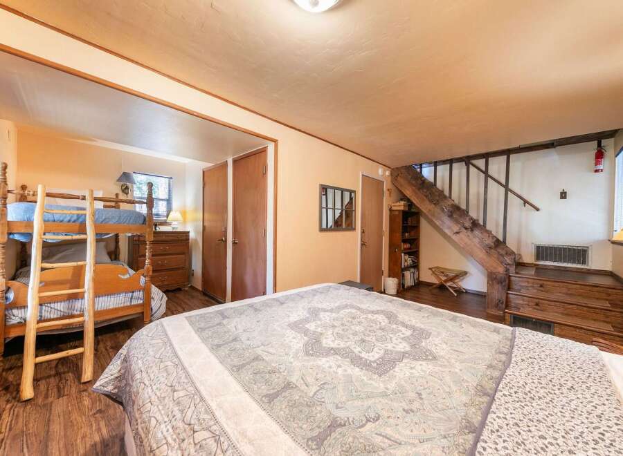 This charming bedroom features a cozy bunk bed setup, perfect for families or groups.