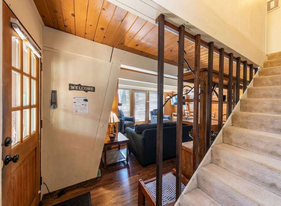 Step into a warm and inviting cabin atmosphere with this charming entryway.