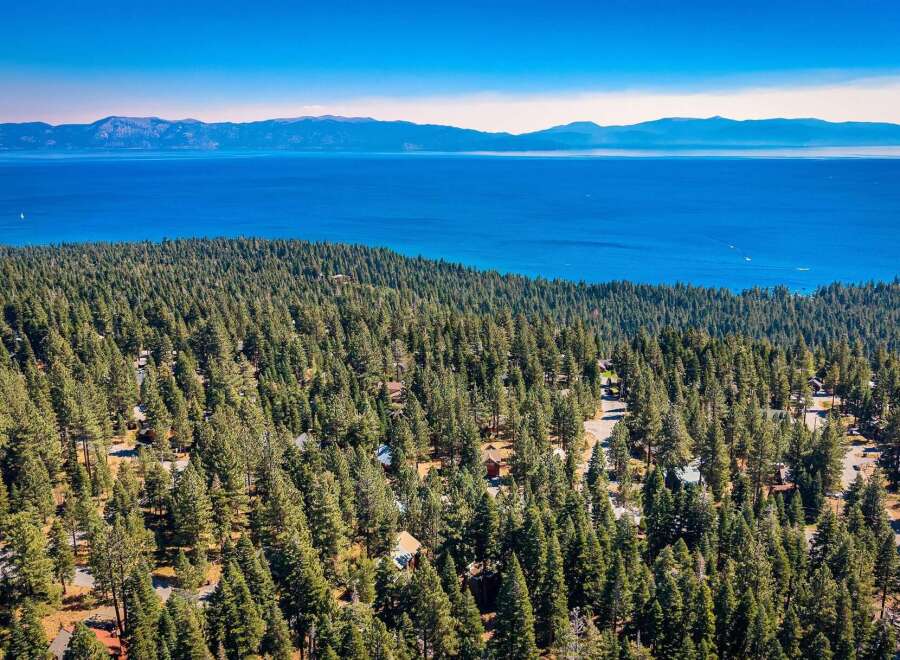 Experience breathtaking views of Lake Tahoe from this stunning property nestled amidst a dense pine forest.