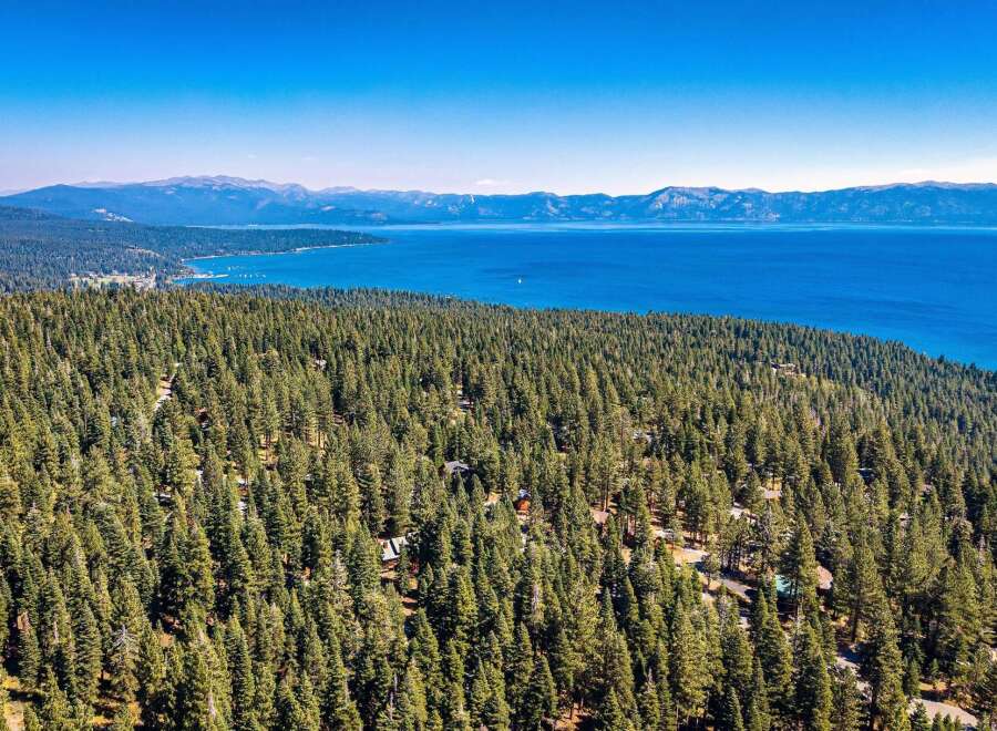 Experience breathtaking views of Lake Tahoe from this stunning property nestled amidst a lush pine forest.