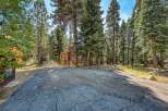 Nestled amongst towering pine trees, this charming A-frame cabin offers a serene mountain getaway.