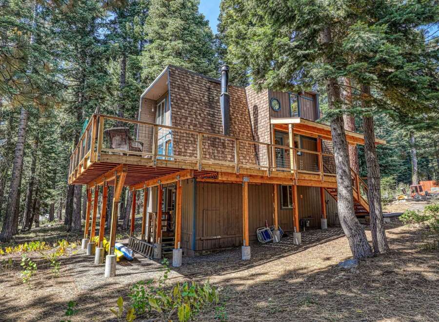 Experience the charm of this rustic mountain home, nestled amongst towering pine trees.