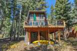 Experience the perfect mountain getaway in this charming cabin nestled among tall pine trees.