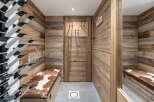 This ski room features a rustic wooden paneling and a practical ski boot rack system.