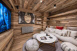 Experience ultimate relaxation in this cozy media room, featuring a large sectional sofa perfect for movie nights.