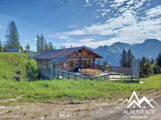 Experience breathtaking mountain views from this charming wooden chalet, perfect for a serene getaway.