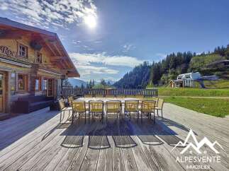 Enjoy breathtaking mountain views from this charming wooden chalet, perfect for a serene getaway.