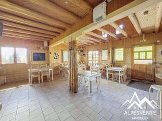 Experience rustic charm in this mountain lodge dining area, featuring warm wooden interiors and ample natural light.