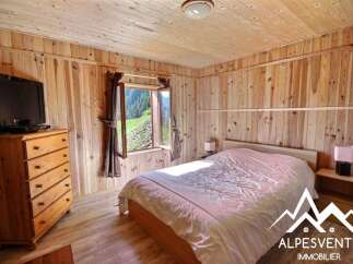 Experience cozy mountain living in this charming wooden cabin bedroom.