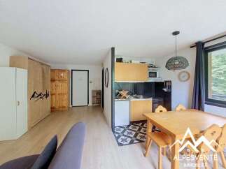 Discover this charming apartment featuring a well-equipped kitchenette and a cozy dining area, perfect for family meals.
