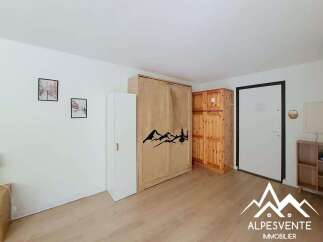 This spacious room features a large wooden wardrobe and a tall white cabinet, offering ample storage solutions.