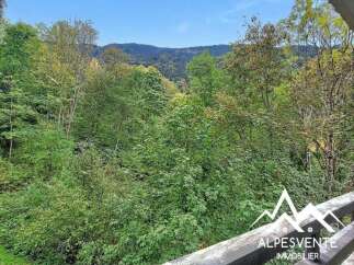 Experience the tranquility of nature from this property, offering a breathtaking view of lush green forests and rolling hills.