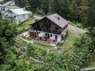 Discover this charming multi-level home nestled amidst lush greenery, offering a serene retreat.