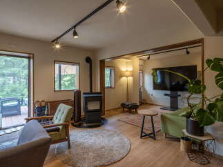 Experience cozy living in this inviting space, featuring a modern wood-burning stove perfect for chilly evenings.