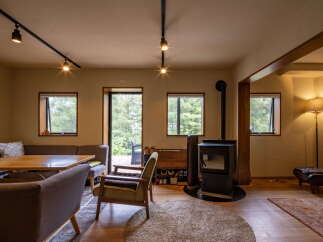 Experience cozy living in this charming room featuring a wood-burning stove, perfect for chilly evenings.