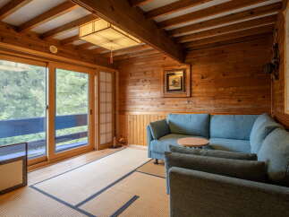 Experience serene living in this beautifully appointed room featuring natural wood paneling and a traditional tatami floor.