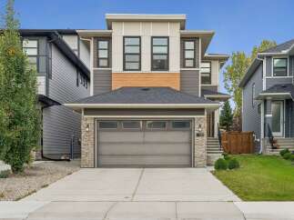 Discover modern living in this stunning townhouse featuring a sleek exterior with stone accents and wood detailing.