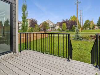 Step out onto the spacious wooden deck, perfect for enjoying the outdoors.