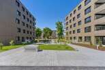 Discover modern living in this contemporary apartment complex featuring sleek, tan-colored facades and abundant natural light.